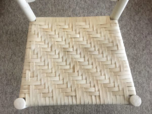 White wicker chair seat with woven herringbone pattern